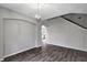 Living area with hardwood floors, neutral paint, and an arched doorway at 10909 Observatory Way, Tampa, FL 33647
