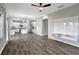 Open-concept floorplan featuring hardwood floors, light grey walls, a ceiling fan, and an updated kitchen at 10909 Observatory Way, Tampa, FL 33647