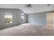 Spacious main bedroom with vaulted ceiling, carpet flooring, and multiple windows at 10909 Observatory Way, Tampa, FL 33647