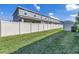 Large backyard with a white privacy fence and lush green grass at 1109 Lady Gouldian Ct, Tampa, FL 33613