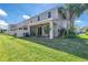 Beautiful backyard patio with a ceiling fan and mature palm trees at 1109 Lady Gouldian Ct, Tampa, FL 33613