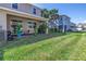 Charming backyard patio with a ceiling fan and lush greenery at 1109 Lady Gouldian Ct, Tampa, FL 33613
