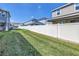 Spacious backyard with a well-maintained lawn and a white privacy fence at 1109 Lady Gouldian Ct, Tampa, FL 33613