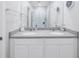 Bathroom featuring dual sinks, a large mirror, and white cabinetry with gray countertop at 1109 Lady Gouldian Ct, Tampa, FL 33613
