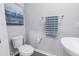 Powder room shows a pedestal sink and a toilet with gray walls and wood-look floors at 1109 Lady Gouldian Ct, Tampa, FL 33613