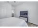 Bright bedroom showcasing a TV, white bedding, and nearby doorway at 1109 Lady Gouldian Ct, Tampa, FL 33613