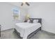 Bright bedroom with gray carpet, ceiling fan, and window letting in natural light at 1109 Lady Gouldian Ct, Tampa, FL 33613