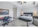 Bedroom with ceiling fan, desk, and large bed with nightstands and lamps at 1109 Lady Gouldian Ct, Tampa, FL 33613