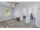 Bedroom with neutral carpet, ceiling fan, and open doorway to an adjacent room at 1109 Lady Gouldian Ct, Tampa, FL 33613