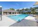 Beautiful community pool and clubhouse with lounge chairs and palm trees at 1109 Lady Gouldian Ct, Tampa, FL 33613