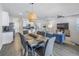 Open concept living and dining area featuring modern furnishings and stylish lighting at 1109 Lady Gouldian Ct, Tampa, FL 33613