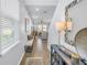 Inviting entryway with wood-look floors, decorative mirror, and view into the living area at 1109 Lady Gouldian Ct, Tampa, FL 33613