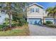 Charming two-story townhome with blue accents, paved driveway, and nicely landscaped front yard at 1109 Lady Gouldian Ct, Tampa, FL 33613
