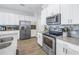 Bright kitchen with stainless steel appliances, white cabinets, and tiled backsplash at 1109 Lady Gouldian Ct, Tampa, FL 33613