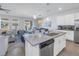 Open kitchen with stainless steel appliances, quartz countertops, and a view of the living area at 1109 Lady Gouldian Ct, Tampa, FL 33613