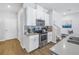 Bright kitchen with stainless steel appliances, white cabinets, and wood-look floors at 1109 Lady Gouldian Ct, Tampa, FL 33613