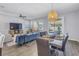 Open-concept living and dining area with modern furnishings and plenty of natural light at 1109 Lady Gouldian Ct, Tampa, FL 33613