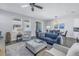 Inviting living room with a plush blue sofa, neutral-toned seating, and stylish decor at 1109 Lady Gouldian Ct, Tampa, FL 33613