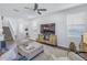 Spacious living room with a large TV, modern furniture, and neutral color palette at 1109 Lady Gouldian Ct, Tampa, FL 33613
