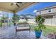 Covered outdoor patio features tile floor and a grill, with a view of the fenced yard at 1109 Lady Gouldian Ct, Tampa, FL 33613