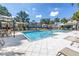 Community pool surrounded by lounge seating, shade, and palm trees at 1109 Lady Gouldian Ct, Tampa, FL 33613