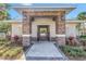 Pool entrance with stone pillars and landscaping at 1109 Lady Gouldian Ct, Tampa, FL 33613