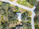 Stunning aerial view of a property with mature trees providing shade and privacy and street access on two sides at 11301 Sandpine Rd, Riverview, FL 33569