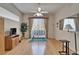 Living room features hardwood floors, large window, curtains, and neutral decor at 11301 Sandpine Rd, Riverview, FL 33569