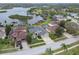 Aerial view of the home, lush landscaping, private pool, and waterfront with dock access at 1204 Blackrush Dr, Tarpon Springs, FL 34689