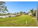 Landscaped backyard with dock and waterfront access at 1204 Blackrush Dr, Tarpon Springs, FL 34689