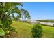 Beautiful waterfront backyard with tropical landscaping and dock at 1204 Blackrush Dr, Tarpon Springs, FL 34689