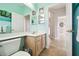 Bathroom featuring a light wood vanity, ample mirror space and access to other rooms in the house at 1204 Blackrush Dr, Tarpon Springs, FL 34689
