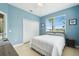 Bedroom with light blue walls, double bed, closet, and view to the outdoors at 1204 Blackrush Dr, Tarpon Springs, FL 34689
