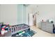 bedroom with custom paint, grey furniture, and light wood floors at 1204 Blackrush Dr, Tarpon Springs, FL 34689