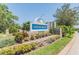 Landscaped community entrance sign with 'River Watch' inscription and well-maintained greenery at 1204 Blackrush Dr, Tarpon Springs, FL 34689