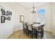 Formal dining room with a large window, chandelier, and seating for eight at 1204 Blackrush Dr, Tarpon Springs, FL 34689