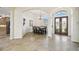 Elegant dining room featuring tile flooring, an arched entryway, and a modern chandelier at 1204 Blackrush Dr, Tarpon Springs, FL 34689