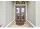 Close-up of the beautiful double front doors with decorative glass panels and golden hardware at 1204 Blackrush Dr, Tarpon Springs, FL 34689