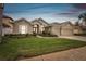 Charming home with a well-manicured lawn, colorful flower beds, and a three-car garage at 1204 Blackrush Dr, Tarpon Springs, FL 34689