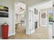Hallway featuring tile floors with an archway and access to other living spaces and outdoor pool views at 1204 Blackrush Dr, Tarpon Springs, FL 34689