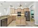 Traditional kitchen with wood cabinets, granite countertops, and stainless steel appliances at 1204 Blackrush Dr, Tarpon Springs, FL 34689