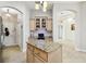 Kitchen island featuring granite countertops and a nearby workspace and storage at 1204 Blackrush Dr, Tarpon Springs, FL 34689