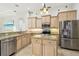 Bright kitchen featuring stainless steel appliances, granite countertops, and an island at 1204 Blackrush Dr, Tarpon Springs, FL 34689