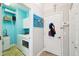 Laundry room with white cabinets, and modern washer and dryer, transitioning to a hallway at 1204 Blackrush Dr, Tarpon Springs, FL 34689