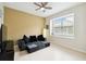 Sitting room with a patterned wallpaper, ceiling fan, grey sofa, and natural light at 1204 Blackrush Dr, Tarpon Springs, FL 34689