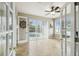 Living room with a view of the pool through sliding glass doors, ceiling fan, and neutral paint at 1204 Blackrush Dr, Tarpon Springs, FL 34689