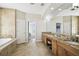 The luxurious primary bathroom with dual vanities, soaking tub, and walk-in closet at 1204 Blackrush Dr, Tarpon Springs, FL 34689