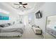 Large primary bedroom with neutral walls, tray ceiling, and access to lanai at 1204 Blackrush Dr, Tarpon Springs, FL 34689