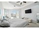 Spacious primary bedroom features a ceiling fan, sliding doors, and a TV at 1204 Blackrush Dr, Tarpon Springs, FL 34689