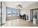 Well-lit office space with large windows offering serene views, complete with ceiling fan at 1204 Blackrush Dr, Tarpon Springs, FL 34689